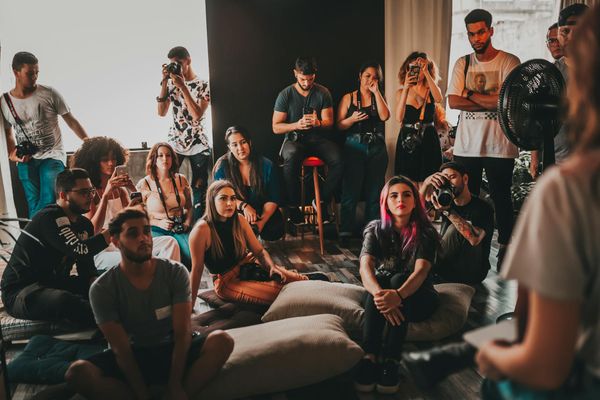 Group of diverse people meditating in a bright, modern studio.